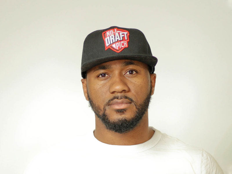 Black Chicago cap with front embroidery, curved brim, and adjustable strap for unisex minimalist streetwear style